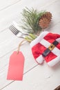 Closeup of Christmas Santa costume with fork, knife, green fir decor