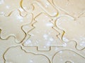 A closeup of a Christmas tree cutout and other holiday stencils or shapes including gingerbread man cut in raw sugar cookie dough Royalty Free Stock Photo