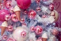 Closeup of Christmas tree decorated with pink shiny balls and icecreams