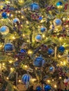 closeup Christmas tree decorated with white and blue glass spheres in living room at home parties Royalty Free Stock Photo