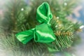 Closeup of Christmas-tree decoration. Decorative green bow-knot in a fur tree