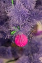 Closeup of Christmas-tree decoration. Decorative pink bauble in a fur tree