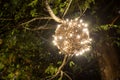 Closeup of Christmas-tree decorations. Ball with bright string lights hanging on a tree Royalty Free Stock Photo