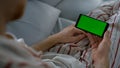 Closeup chroma key smartphone in hands. Unknown man resting with gadget morning.