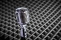Closeup of chrome retro condenser microphone on acoustic foam panel background Royalty Free Stock Photo