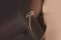 Closeup chromium-plated Logotype, Tesla car model Y in liquid silver dubbed Mercury Silver Metallic color, popular passenger