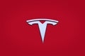 Closeup chromium-plated Logotype Tesla Motors on red hood, most popular passenger electric car in world, Elon Musk, Tesla is an