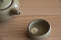Closeup, chrysanthemum tea in ceramic cup, teapot spout. Natural tea is good for health