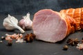Closeup chunk of smoked gammon with salt, spices and two garlic