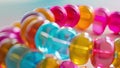 Closeup of a chunky bracelet made from recycled plastic beads. The beads have a glossy finish and various colors adding