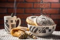 Closeup of cinnamon rolls in a bowl with other pasties and a cup of steaming tea Royalty Free Stock Photo
