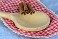 Closeup of cinnamon sticks on a wooden spoon Royalty Free Stock Photo