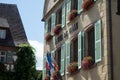 The city hall with french flag in the medieval village of Turckheim in France, with text in facade, hotel de ville in