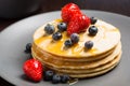 Closeup of classic american pancakes, with strawberries and fresh blueberries Royalty Free Stock Photo