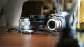 Closeup of classic camera on a wooden desk with wrist watch and len equipment selected focus. Background with a beautiful Royalty Free Stock Photo