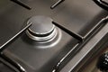 Close-up clean new kitchen gas stove cooker knob heat volume switch elegant metal steel black and white. Royalty Free Stock Photo