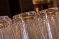 Closeup of shiny pint glasses in a row tipping from right to left
