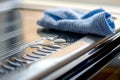 closeup of cleaning a microwaves touchpad with a damp cloth Royalty Free Stock Photo