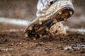 closeup of cleated feet digging into the batters box dirt