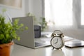 Closeup clock and eyeglasses on office desk