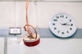 Closeup clock and installation and repair of electric cable, smoke detector, fire alarm system before installing. Concept testing Royalty Free Stock Photo