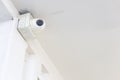 Closeup of closed circuit television camera or CCTV and box control on white concrete ceiling Royalty Free Stock Photo