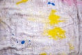 Closeup of a cloth with yellow and blue paint drops and splatters Royalty Free Stock Photo