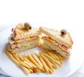 Closeup of club sandwiches with chickan, egg, salad, toast bread and french fries served on white plate Royalty Free Stock Photo