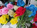A closeup cluster of very colorful artificial flowers on display for sale