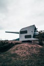 Closeup of a coastal artillery on a small hill under the cloudy sky