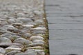 Closeup cobblestone, pebble old pavement with wooden flooring