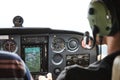 Closeup of a cockpit of cessna skyhawk 172 airplane with two pilots. Royalty Free Stock Photo