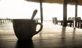 Closeup coffee cup at beach cafe in silhouette Royalty Free Stock Photo