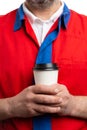 Closeup of coffee cup held by supermarket employee