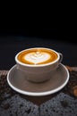 Closeup Coffee latte art leave from fresh milk foam on side of wood Royalty Free Stock Photo