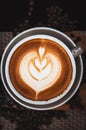 Closeup Coffee latte art leave from fresh milk foam on side of wood Royalty Free Stock Photo