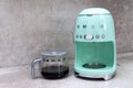 Closeup coffee maker SMEG brand. And freshly brewed coffee on the kitchen table Royalty Free Stock Photo