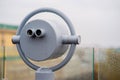 Closeup coin operated binoculars overlooking after rain