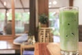 Closeup Cold matcha green tea in clear glass Placed on a wooden table Royalty Free Stock Photo