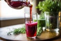 a closeup of cold press juice pouring into a glass