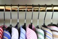 Closeup of collars of men's shirts hanging on a rail Royalty Free Stock Photo