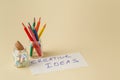 Closeup of color pencils in glass jar with notes Royalty Free Stock Photo