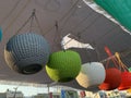 Closeup of colorful baskets with chains hanged from a thread at an open-air market Royalty Free Stock Photo