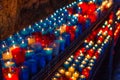 Closeup of colorful candles burning in the tunnel of Covadonga, Cangas de Onis, Asturias, Spain. Spirituality Royalty Free Stock Photo