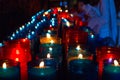 Closeup of colorful candles burning in the tunnel of Covadonga, Cangas de Onis, Asturias, Spain. Spirituality Royalty Free Stock Photo