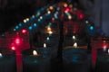 Closeup of colorful candles burning in the tunnel of Covadonga, Cangas de Onis, Asturias, Spain. Spirituality Royalty Free Stock Photo