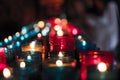 Closeup of colorful candles burning in the tunnel of Covadonga, Cangas de Onis, Asturias, Spain. Spirituality Royalty Free Stock Photo