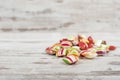 Closeup of colorful Christmas candies on a white wooden surface Royalty Free Stock Photo