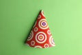 Closeup of a colorful cone-shaped party hat on green background