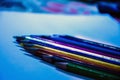 Closeup of colorful drawing pencils line up on the white paper